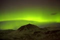 Northern lights with snowy mountains in the foreground Royalty Free Stock Photo