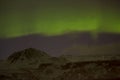 Northern lights with snowy mountains in the foreground Royalty Free Stock Photo