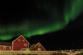 Northern lights and starlight sky over two red living houses, Nu Royalty Free Stock Photo