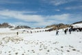 Northern Mongolia. Golden Eagle Festival 2023, cluster of tourists on a snowy slope. Berkutchi competitions in the ability to hunt