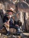 Northern Mongolia. Old Mongolian hunter with a golden eagle rest