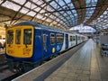 A Northern Rail commuter train waiting at a deserted Platform 3 at Lime Street Station in Liverpool, UK