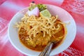 Northern Thai Cuisine with spicy curry soup topping with Lemon, Pickled, Lettuce