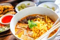 Thai Curried noodle soup Khao soi with chicken meat and spicy coconut milk