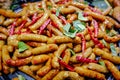 Thai spicy herbal sausages freshly cooked in a pan. Royalty Free Stock Photo