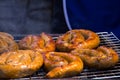 Northern Thai spicy sausage Sai Aua grill on grates in street food market. Selective focus