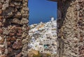 The northern tip of Oia, Santorini framed by a stone window in Oia castle Royalty Free Stock Photo