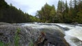 Northern turbulent river beyond Arctic Circle. Stream on threshold of Kolva or Kolvitsi in autumn