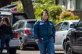 A black female detective from LAPD`s metro division walks by police vehicles