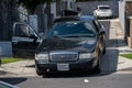 A Ford Crown Victoria unmarked police car parked with its passenger door open at the scene