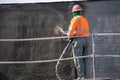 A construction worker sprays concrete on a wall at a work site at 9123 Shirley Ave.