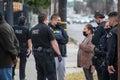 LAPD officers and supervisors question witnesses at an assault