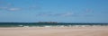 Northumberland white sandy beach and coast at Bamburgh north east England UK panoramic view Royalty Free Stock Photo