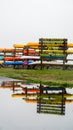 Calf Pasture beach view in rainy day with kayaks storage and reflections in water