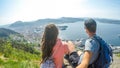 Norway - A couple sittting on a rock, with the view on Bergen