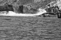Norway on the fjord, spray on rocks in black and white. Water splashing on rocks Royalty Free Stock Photo