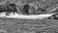 Norway on the fjord, spray on rocks in black and white. Water splashing on rocks Royalty Free Stock Photo