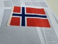 Norway flag displayed on a table with printed text background Royalty Free Stock Photo