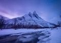 Norway. Frozen river and mountain. A classic view in Norway during winter. Cold weather and a snow storm.