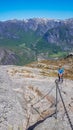 Norway - A girl climbing up a steep rock