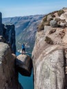 Norway - A girl standing on Kjerag with view on Lysefjorden