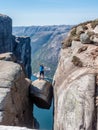 Norway - A girl standing on Kjerag with view on Lysefjorden