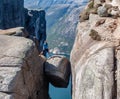 Norway - A girl standing on Kjerag with view on Lysefjorden