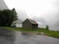 Norway, lakeside cottage under snow mountain