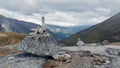 Norway landscape, fancy driftwood on a boulder on high stone plateau in the mountains with dried grass in the national park valley