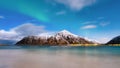 Norway, Lofoten island. Mountains and reflections on water at night. Winter landscape. The sky with stars and Aurora borealis. Nat Royalty Free Stock Photo