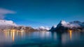 Norway, Lofoten island. Mountains and reflections on water at night. Winter landscape. The sky with stars and Aurora borealis. Royalty Free Stock Photo