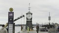 Norway, Oslo - July 29, 2022: Clock on pier in European town. Action. Small clock tower on city pier. Workers and Royalty Free Stock Photo