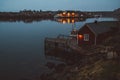 Norway rorbu houses and mountains rocks over fjord landscape scandinavian travel view Lofoten islands. Night landscape. Royalty Free Stock Photo