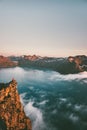 Norway vacations travel man sitting on the edge cliff Royalty Free Stock Photo