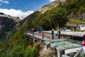 Norway ÃËrnesvingen vantage point with tourists admiring the Geiranger fjord