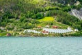 Norwegian agricultural farm with greenhouses on the hill at Naeroy fjord,  Aurlan, Sogn og Fjordane county, Norway Royalty Free Stock Photo