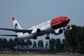 Norwegian Air Line plane flying to various destinations Royalty Free Stock Photo