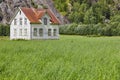 Norwegian antique traditional wooden house with grass and mountain.