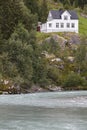 Norwegian antique traditional wooden house, river and hill