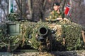 Norwegian Army armored tank with cannon and camouflage coating and other military vehicles with soldier