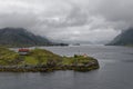 A Norwegian Cabin and Lighthouse on a small Island in the middle of a Fjord