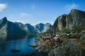 Norwegian fishermens cabins at a lake shore with fjords on the background