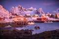 Norwegian fishing village with red rorbu houses, mountain peaks and sea coast winter landscape, Lofoten islands, Norway Royalty Free Stock Photo