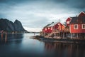 Norwegian fishing village Reine at the Lofoten Islands in Norway. Dramatic sunset clouds moving over steep mountain Royalty Free Stock Photo