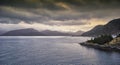 Dawn over a Norwegian Fjord as a Vessel heads out to the North Sea. Royalty Free Stock Photo
