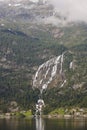 Norwegian fjord landscape with waterfall and houses. Sorfjorden. Norway.