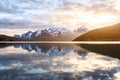 Norwegian fjord at sunset with dramatic sky, reflection in water Royalty Free Stock Photo