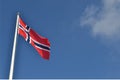 Norwegian flag against blue sky Royalty Free Stock Photo