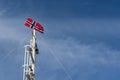 Norwegian flag against the blue sky Royalty Free Stock Photo