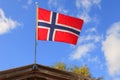 The norwegian flag against blue sky Royalty Free Stock Photo